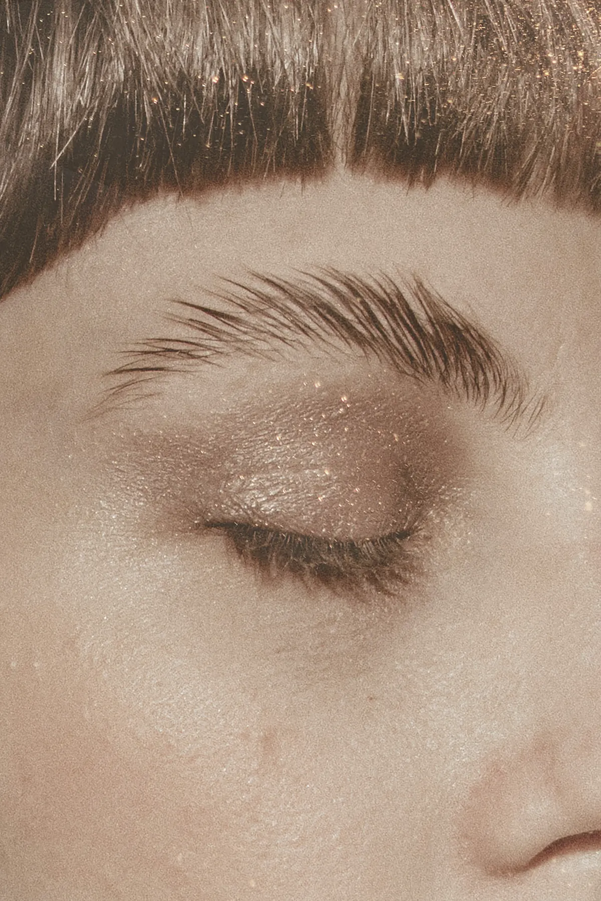 A closed eye with soft brows
